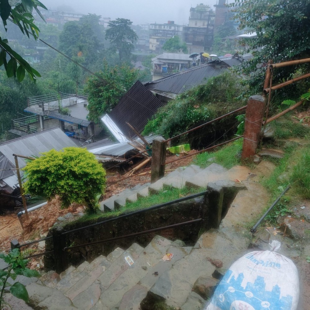 The site of the landslide triggered by incessant rainfall in Mon town on July 19, which claimed at least eight lives and caused extensive damage to houses and other property. Search and rescue operations are underway. (Photo: Special Arrangement)